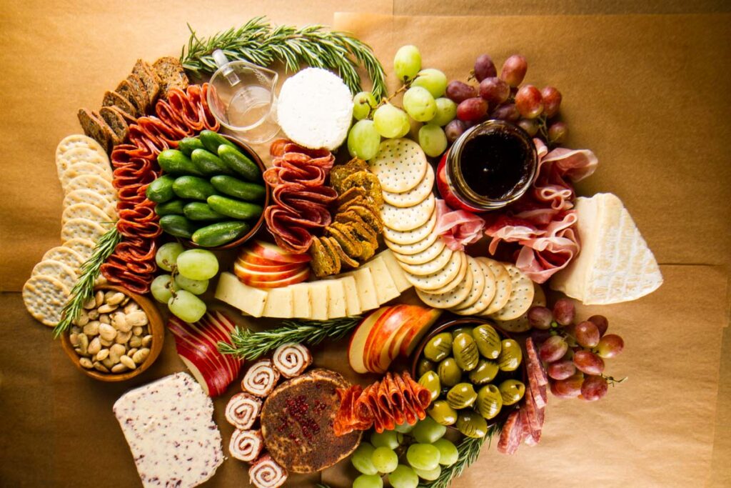 Step seven of building a $100 Trader Joe's grazing table: adding rosemary sprigs as a garnish
