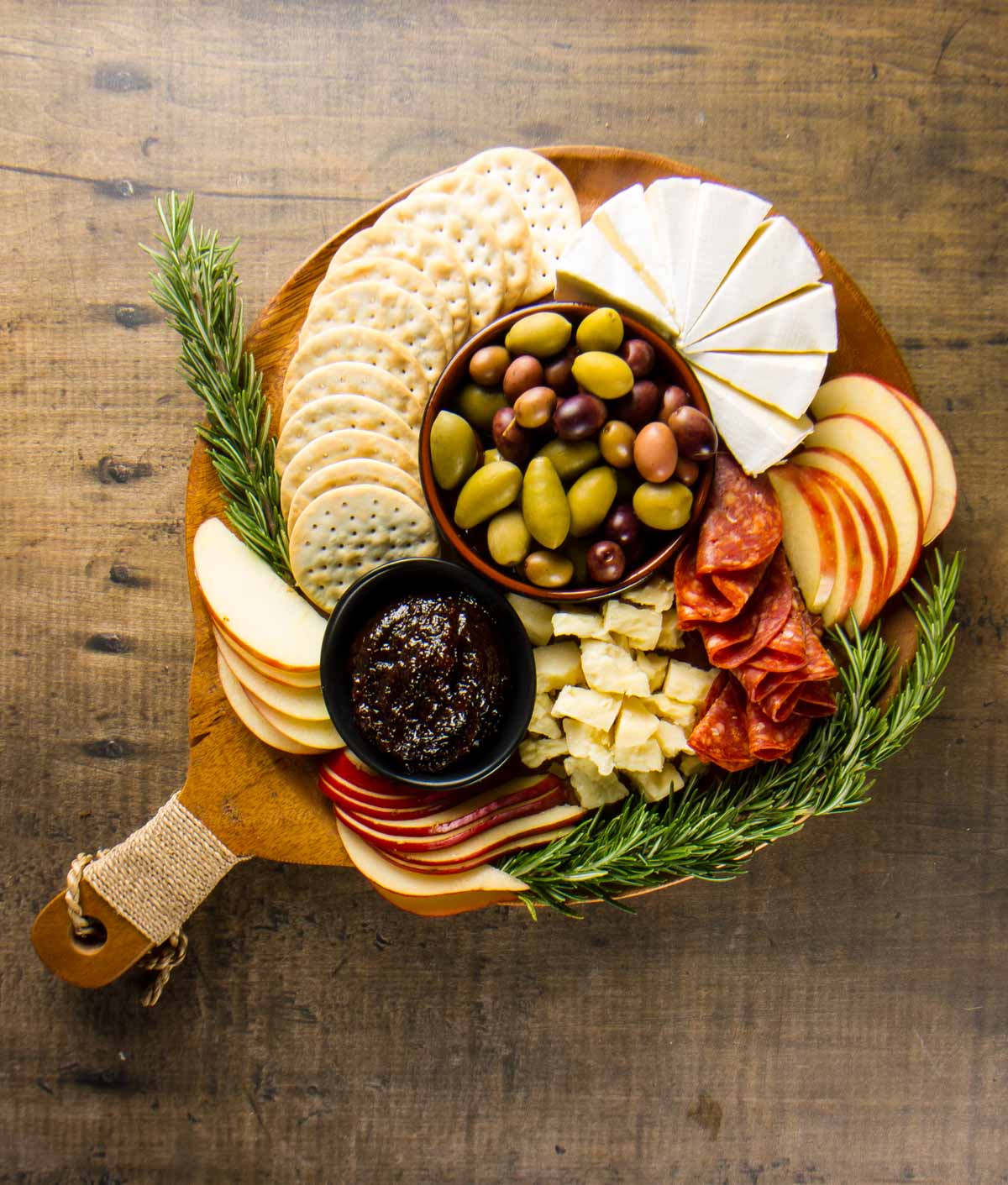 a small, round charcuterie board showing how much is needed to serve 4-6 people