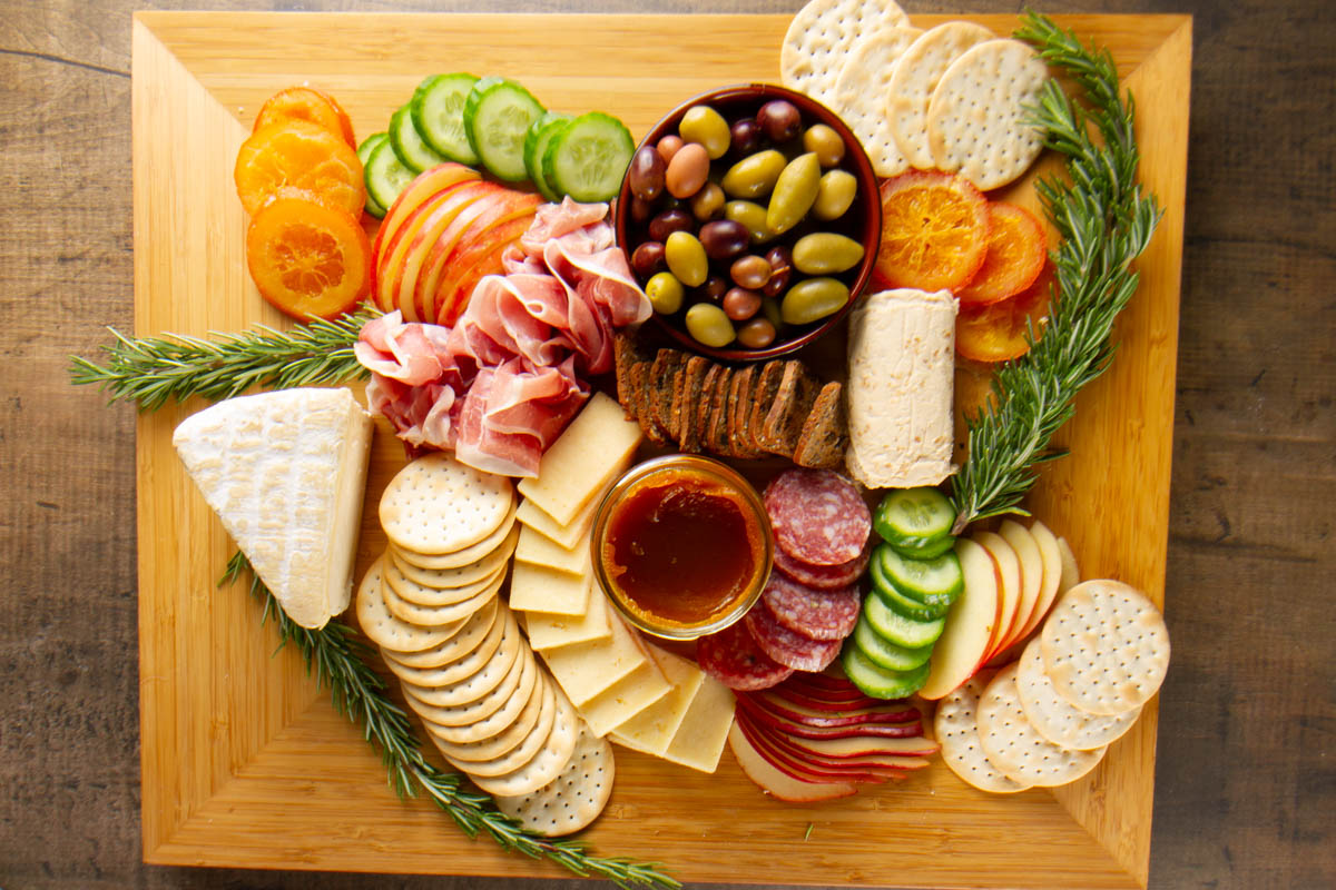 a square charcuterie board showing how much is needed to serve 8-10 people