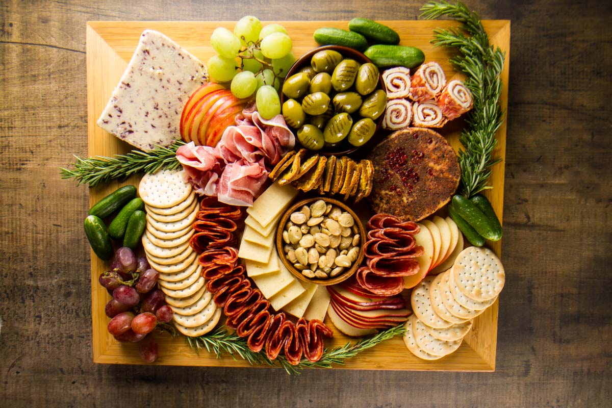 a square charcuterie board showing how much is needed to serve 12-15 people