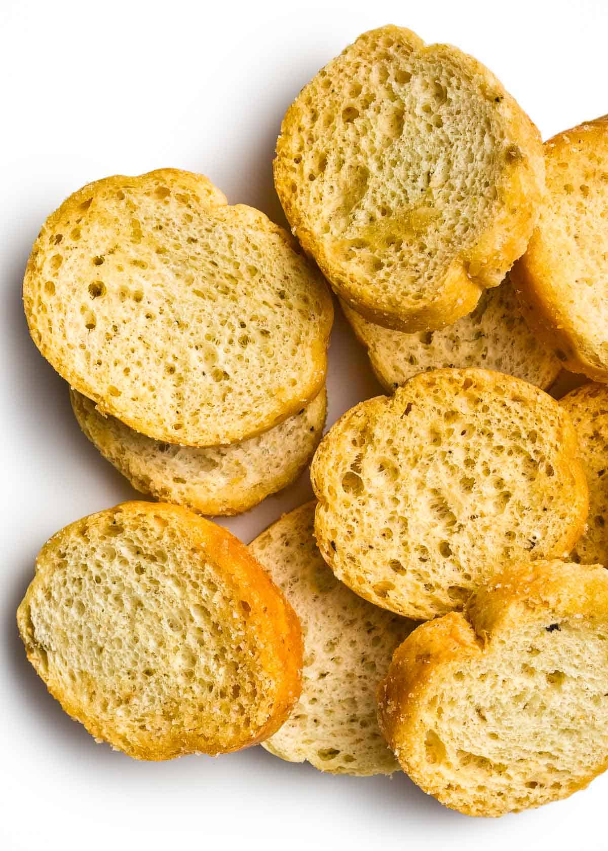 a closeup of freshly toasted crostini on a white background